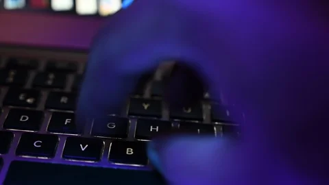 Use a computer keyboard  blue hand light ultraviolet 動画素材 112896864