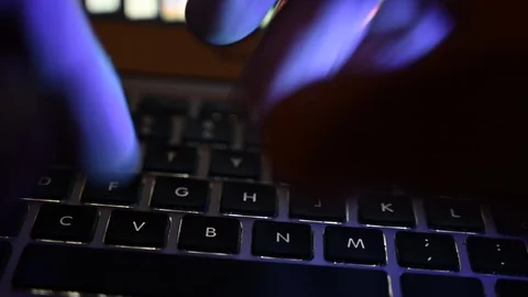 Use a computer keyboard  blue hand light ultraviolet Stock Footage 113230316
