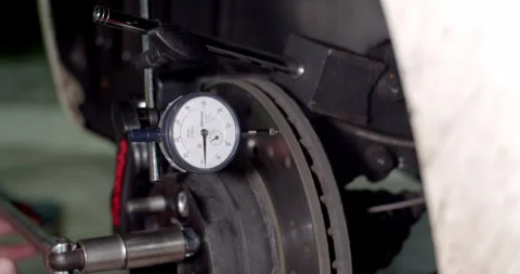 Use a dial gauge to measure the smoothness of the brake disc. Stock Footage 294568329