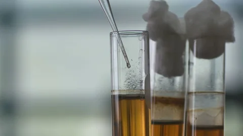 Use dropper sucking the reagent from test tube Stock Footage 93706415