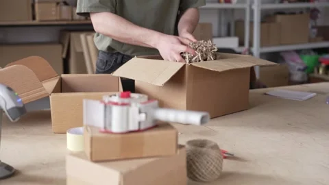 The use of eco-friendly packaging, Shredded cardboard, recycled paper Stock Footage 306824938