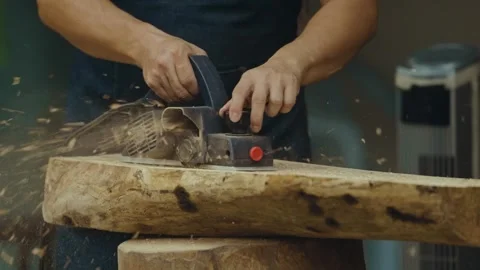Use an electric hand planer to flatten and refine wood surface Stock Footage 266866699