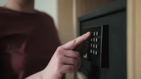 Use electronic safe entering combination of numbers to lock or unlock door. Stock Footage 152467020
