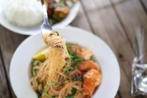 Use a fork to scoop Stir-fried Vermicelli with Water Mimosa with shrimps Stock Photos