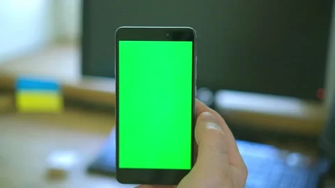 Use green screen for copy space closeup. Chroma key mock-up on smartphone in Stock Footage 204764479