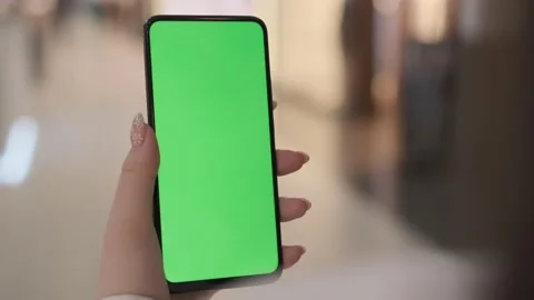 Use green screen for copy space closeup. Chroma key mock-up on smartphone in Stock Footage 212244323