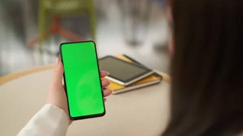 Use green screen for copy space closeup. Chroma key mock-up on smartphone in Stock Footage 212244713