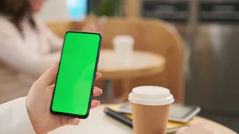 Use green screen for copy space closeup. Chroma key mock-up on smartphone in Stock-Footage 219242779