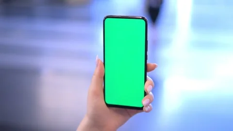 Use green screen for copy space closeup. Chroma key mock-up on smartphone in Stock Footage 249067607