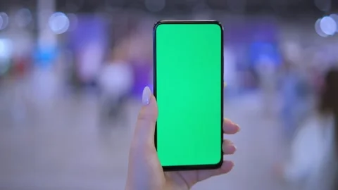 Use green screen for copy space closeup. Chroma key mock-up on smartphone in Stock Footage 249954276