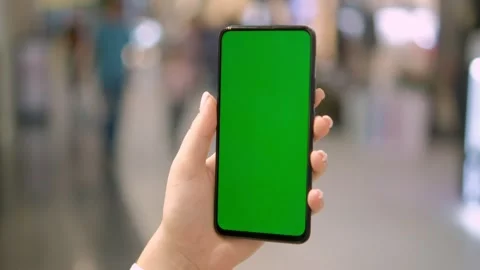 Use green screen for copy space closeup. Chroma key mock-up on smartphone in Stock Footage 258654669