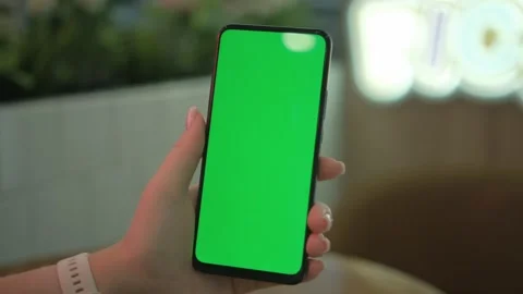 Use green screen for copy space closeup. Chroma key mock-up on smartphone in Stock Footage 258654728