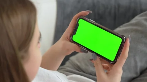 Use green screen for copy space closeup. Chroma key mock-up on smartphone in Stock Footage 262077166