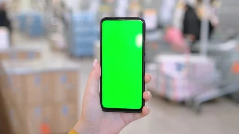 Use green screen for copy space closeup. Chroma key mock-up on smartphone in Stock Footage 275359069
