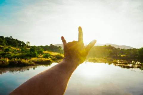 Use hand to touch the sun light in the morning, Love sign show by hand, Yello Stock Photos