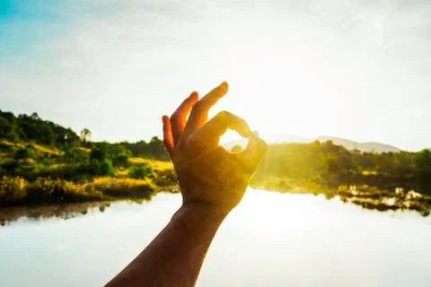 Use hand to touch the sun light in the morning, Pick up the sun, Close the su Stock Photos