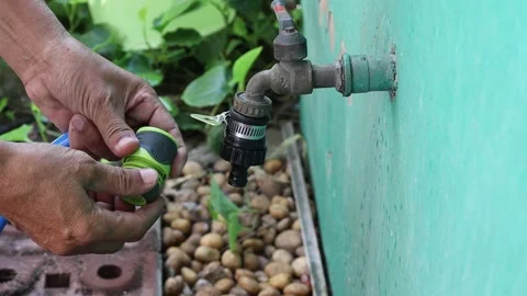 Use hands holding quick water faucet connector Stock Footage 148038910