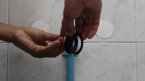 Use hands wrapping to tape at PVC plug stopper for seal blue PVC pipe Stock Footage 147064151