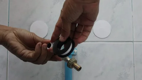 Use hands wrapping to tape at PVC plug stopper for seal blue PVC pipe Stock Footage 147064261