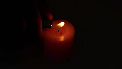 Use a lighter to light a candle. Pink wick. Used in some festivals. Fire give Video stock 188427265