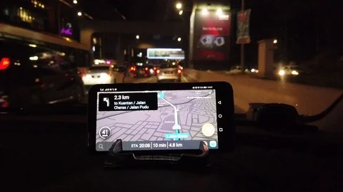 Use of navigation apps using smartphones at the top of the car dashboard at nigh Video stock 106071057