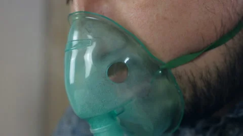 Use a nebulizer and inhaler for treatment. The patient inhales through the Stock-Footage