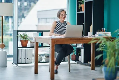 Use online tools to improve your efficiency and productivity. Shot of a mature Stock Photos