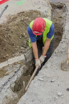 Use pickaxe to dig trench Stock Photos