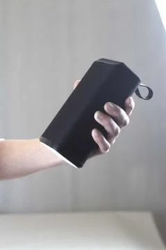 Use portable Bluetooth wireless speaker for music listening. Stock Photos
