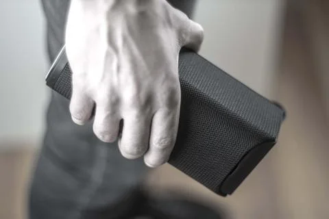 Use portable Bluetooth wireless speaker for music listening. Stock Photos