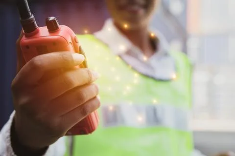 The use of radio communication while working outdoors. Stock Photos