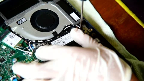 Use screwdriver turn the screw for remove  M.2 NVMe SSD storage Stock Footage 241244934