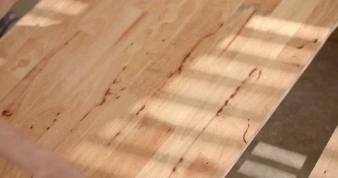 Use a second brush to apply lacquer to the wood to make it look dark and shiny. Stock Footage 222620618