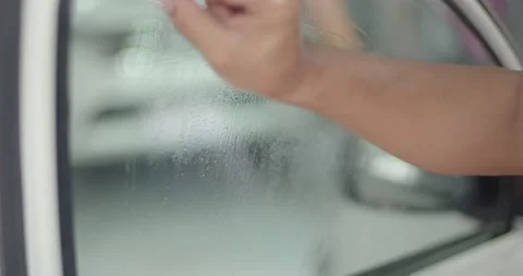 Use a sharp blade to swipe on the glass to remove any glue Stock Footage 223381896