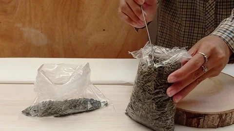Use a spoon to crush the tea powder Stock Footage 139430259