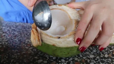Use a spoon to prune the coconut Stock Footage 69184936