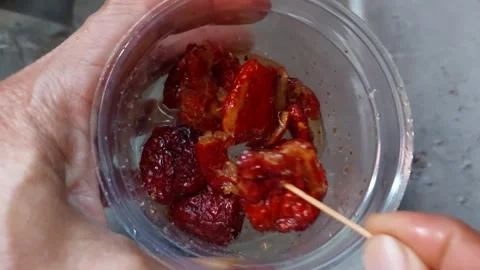 Use a stick to prick the dried jujubes Stock Footage 264803673