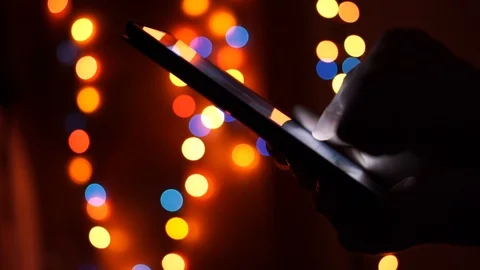 Use a tablet on the background of lights, lamps Video stock 89274440