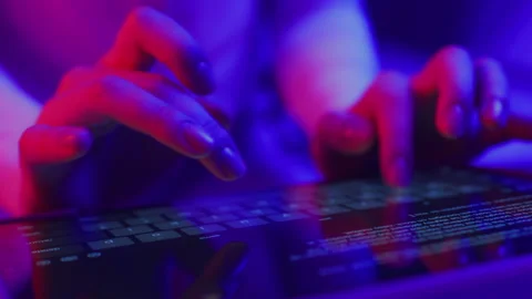 Use of tablet pc in shining neon light. Creative vivid color of ultraviolet red Stock Footage 199483155