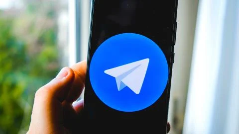 Use Telegram app hand smartphone background Stock Photos
