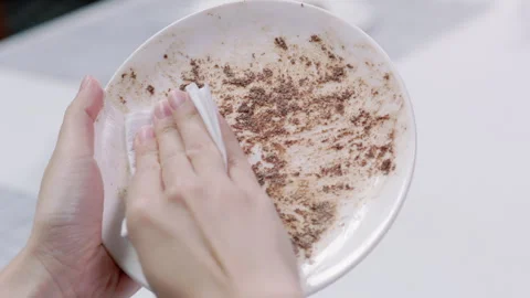 Use tissue paper Gentle Wipe heavycream on Dish from left to right Slowmotion Video stock 242829611