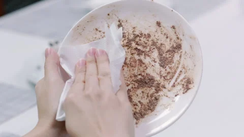 Use tissue paper Wipe heavycream on Dish from left to right Slowmotion 1 Stock-Footage 242829609
