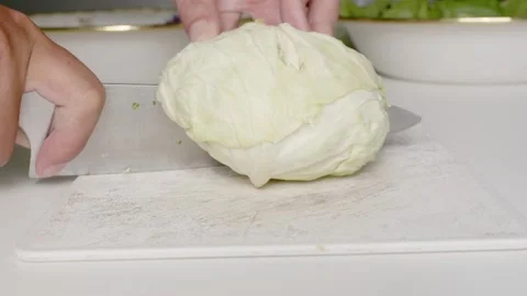Use a vegetable knife on a plastic cutting board to prepare healthy or vegeta Stock Footage 168519326