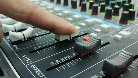 Use your finger to slide the volume up and down on the audio mixer. Stock Footage 231540779