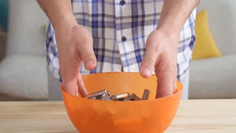 Used AA batteries in the hands of men Video stock 106363397