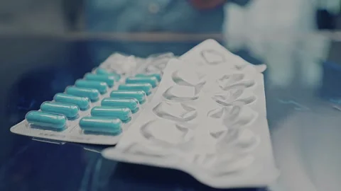 Used and Empty Medicine Blister Packs With Pills on Table 스톡 동영상 340503901