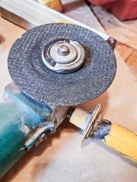 A used angle grinder on a work surface Stock Photos