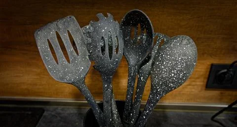 Used black with white dots plastic kitchen utensils Stock Photos