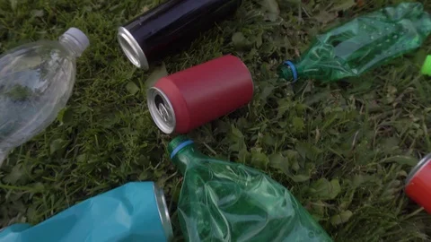 Used bottles and trash scattered around the lawn Stock Footage 120090209