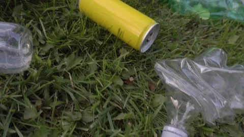 Used bottles and trash scattered around the lawn Stock Footage 120090217
